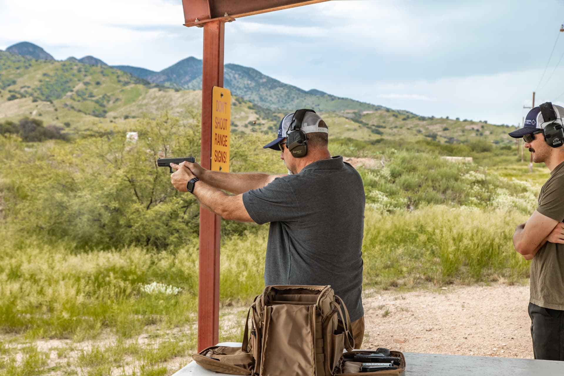 Stillwater Tactical instructor shooting a pistol under a covered range bay in Cochise County, Arizona